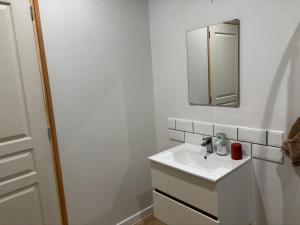 a white bathroom with a sink and a mirror at Studio cosy avec accès jardin in Lunel-Viel