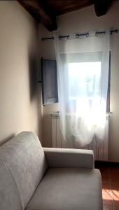 a living room with a couch and a window at Tenute Sciara in Randazzo