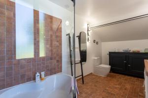 a bathroom with a tub and a toilet at Domaine Cherps Spa - Quietude in Vielleségure