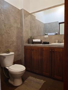 a bathroom with a toilet and a sink at La Casita de Kevin in Los Órganos