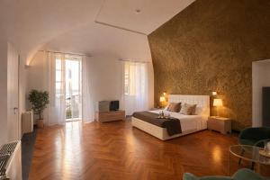 a large bedroom with a bed and a television at Hotel Terme Neronensis in Pozzuoli +179 photos
