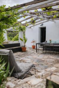 a patio with chairs and tables in a building at Serra Casa in Marvão