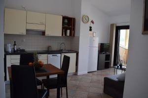 a kitchen and dining room with a table and chairs at Apartment Mali Mol in Vantačići