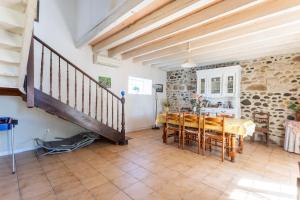 a dining room with a table and a staircase at L'Authentique Maison Béarnaise in Lagor +16 photos
