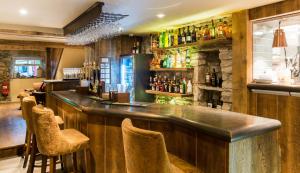 a bar with a counter and chairs in a room at Barley Mow in Burnley