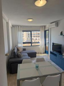 a living room with a couch and a table at FH Altos de Campoamor in Orihuela Costa