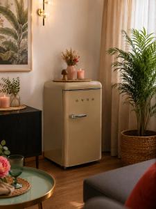 a small refrigerator in a living room with potted plants at Hotel Temple Pradorrey in Astorga