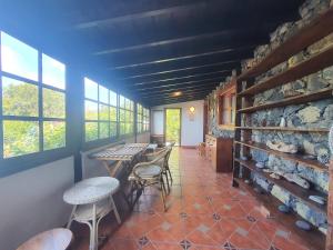 a dining room with tables and chairs and windows at Casa Glorieta in Los Llanos de Aridane