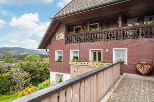 a house with a balcony with flowers on it at Haus Schmid in Lenzkirch