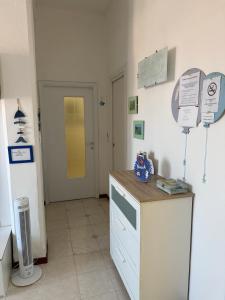 a room with a kitchen with a counter and a door at A un passo dal mare! in Piombino