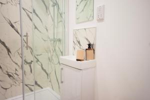a bathroom with a sink and a shower at Derby Luxury Apartments - Curzon in Derby