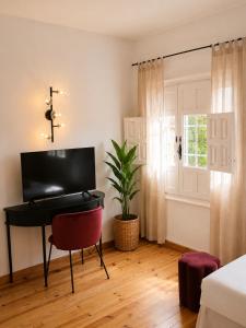a room with a piano and a potted plant at Hotel Temple Pradorrey in Astorga +25 photos