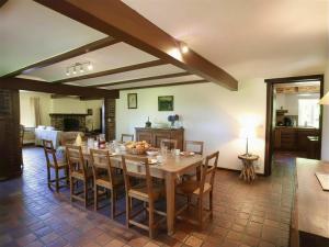 a dining room with a wooden table and chairs at Baronheid in Francorchamps