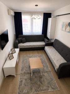 a living room with a couch and a coffee table at Airport Suite Trabzon in Trabzon