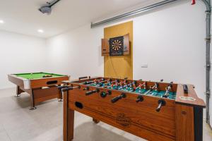 a room with a pool table and a foos ball at Villa Locki with jacuzzi, private pool and sea view in Lourinhã