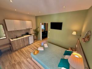 a living room with a bed and a kitchen at ΑVLI Sarti Studios & Apartments no1 in Sarti
