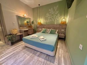a bedroom with a bed and a desk and a sink at ΑVLI Sarti Studios & Apartments no1 in Sarti +16 photos