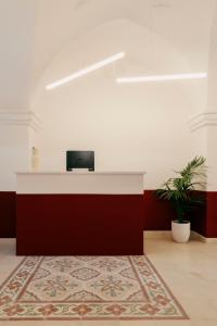 an office with a reception desk and a rug at Villa Gloria in Monteroni di Lecce