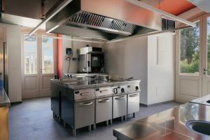 a kitchen with a sink and a stove at Villa Gloria in Monteroni di Lecce