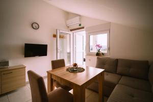 a living room with a table and a couch at Stars in Gornji Karin