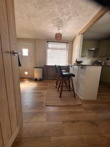 a kitchen with a table and a chair in a room at Cosy double room close to coastal path routes in Barnstaple