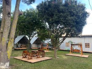 a yard with two benches and a table and trees at Happy Fish Villa in Entebbe