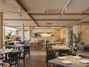 a restaurant with tables and chairs and a bar at Hotel Mediterráneo in Roses +16 photos