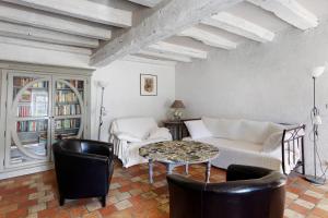 a living room with a couch and a table at La Fromagerie in Mondion