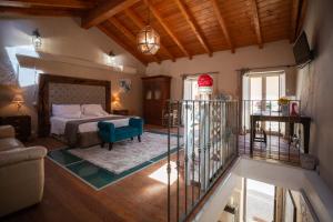 a bedroom with a bed and a blue chair at Cavour Living – Luxury Design Olbia Centro in Olbia