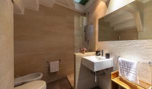 a bathroom with a sink and a toilet at Cavour Living – Luxury Design Olbia Centro in Olbia