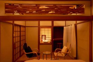 a room with chairs and a table and a window at kawasakike in Takamatsu