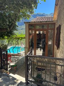 a garden room with a view of a swimming pool at Ethno House Ivanovic in Virpazar