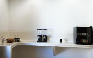 a white counter with two glass bottles on it at Menhir in Olmedo