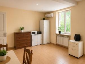 a kitchen with a white refrigerator and a microwave at Sunshine Boutique Hostel in Yerevan +23 photos
