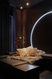 a room with a bed and a table with a light at Your very unique private spa in Berlin Kreuzberg in Berlin