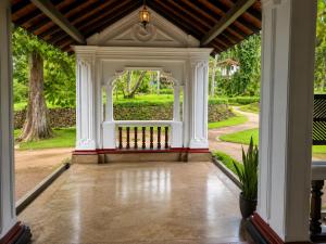 an open entry way to a house with a porch at Basnagoda Walawwa in Ruwanwella