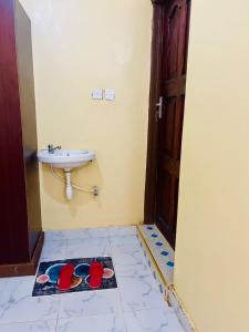 a bathroom with a sink and a sink at Fewa studio in Busia