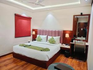 a bedroom with a large bed and a bathroom at Hotel Raaj Palace in Agra +13 photos