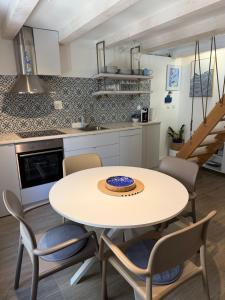 a kitchen and dining room with a table and chairs at Sea Pearl in Komiža +14 photos