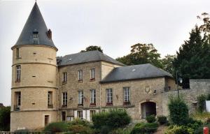 an old stone building with a tower on top of it at Suite Spa Cinta in Trie-Château