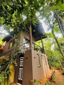 a building with a balcony on top of it at Knuckles Breeze Villas Kandy in Kandy