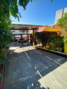 a patio with a table and an umbrella at RioVermelhopoint in Salvador +4 photos