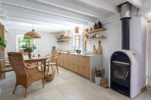 a kitchen with a fireplace and a table and chairs at Eftihia in Katouna +45 photos
