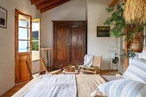 a bedroom with a bed and a wooden cabinet at Eftihia in Katouna