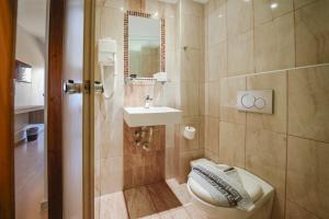 a bathroom with a toilet and a sink at Falassarna Hotel in Chania