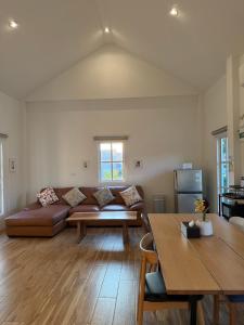 a living room with a couch and a table at Stayokay Sattahip ที่พักสัตหีบ in Sattahip
