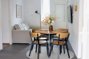 a dining room with a table and chairs and a couch at Dottygal Fiumei UIA in Balatonboglár