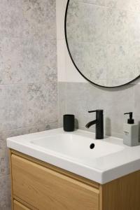 a bathroom sink with a mirror on top of it at Dottygal Fiumei UIA in Balatonboglár