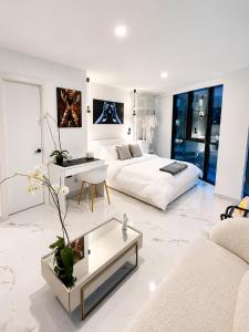 a large white room with a bed and a table at NIDO Boutique Hotel in Quito