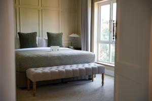 a bedroom with a large bed and a window at Redlands Hotel in Pietermaritzburg